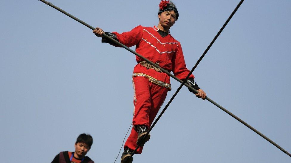 Acrobats perform on a tightrope in Beijing