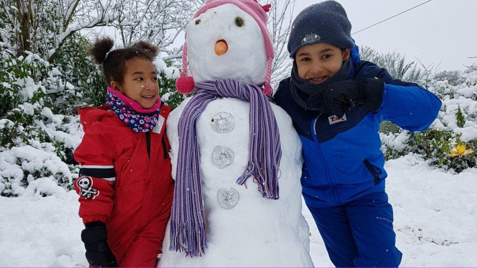 Boy and girl with snowman