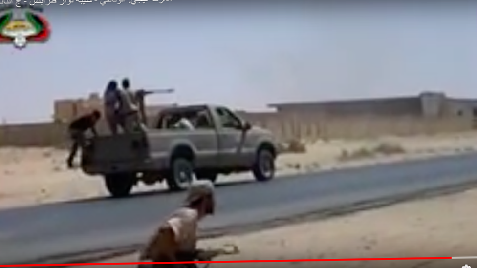 Mohammed Abdallah climbing into a truck in the Libyan revolution