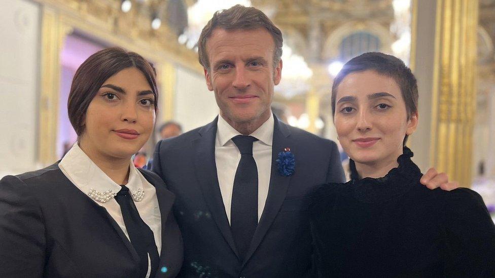 Shima Babaei (L) with French President Emmanuel Macron (C) and fellow female Iranian activist Roya Piraei, at a meeting in Paris, France