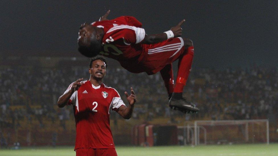 Sudan's Muhannad El Tahir (top) celebrates with a teammate after scoring a goal during their Africa Cup of Nations group I qualification football match at the Al-Merreikh Stadium in Omdurman on 29 March 29