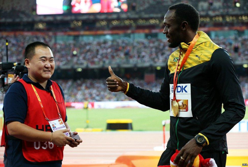 Tao Song of CCTV (left) and Usain Bolt - 28 August 2015