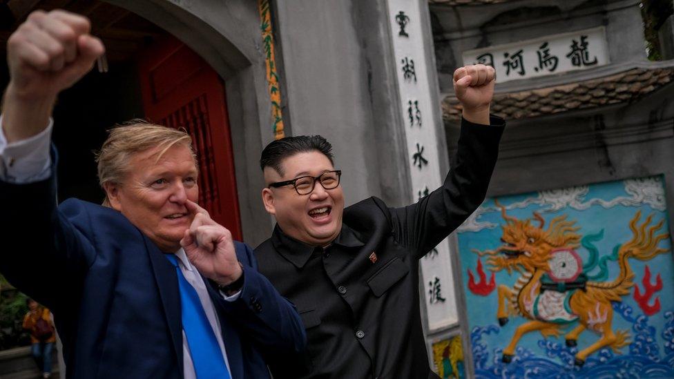 Kim Jung-Un impersonator 'Howard X', and Donald Trump lookalike 'Russell White' posing for photos at Ngoc Son Temple in Hanoi, Vietnam