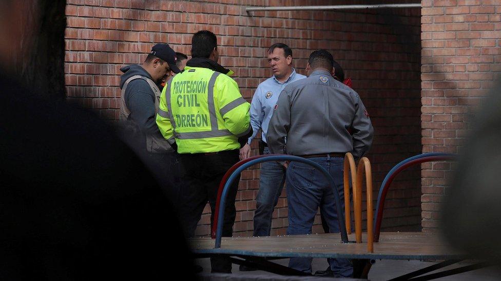 Members of Civil Protection are seen at a private school after a shooting in Torreon