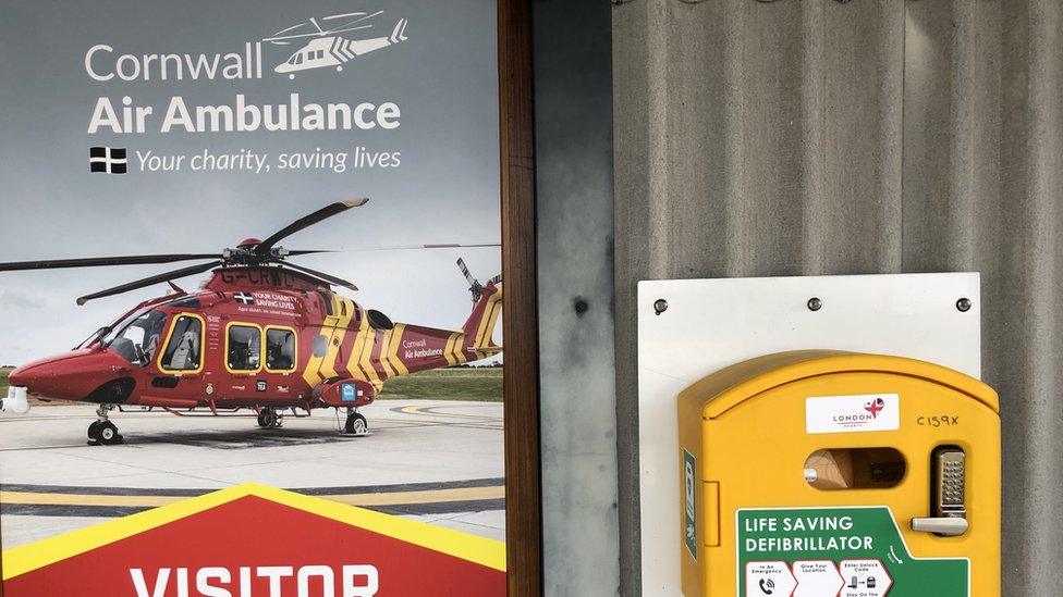 A Cornwall Air Ambulance sign and a defibrillator