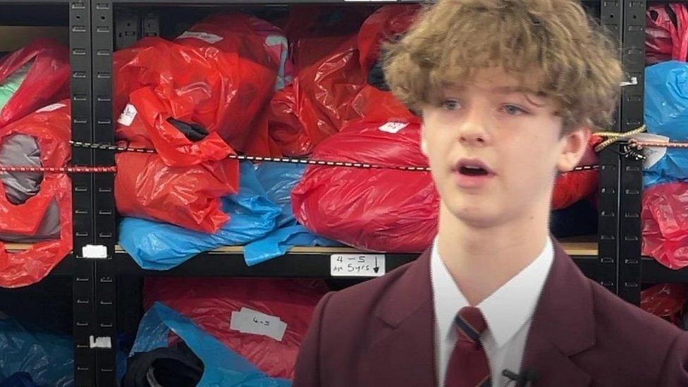 Bertie - schoolboy in front of bags