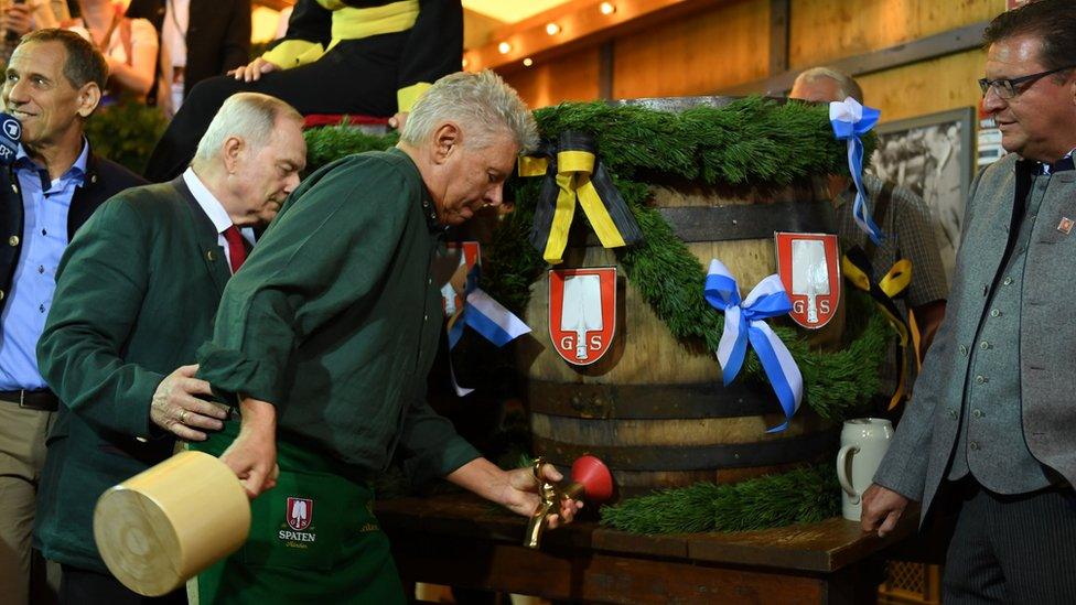 Munich mayor Dieter Reiter prepares to tap the first barrel of beer