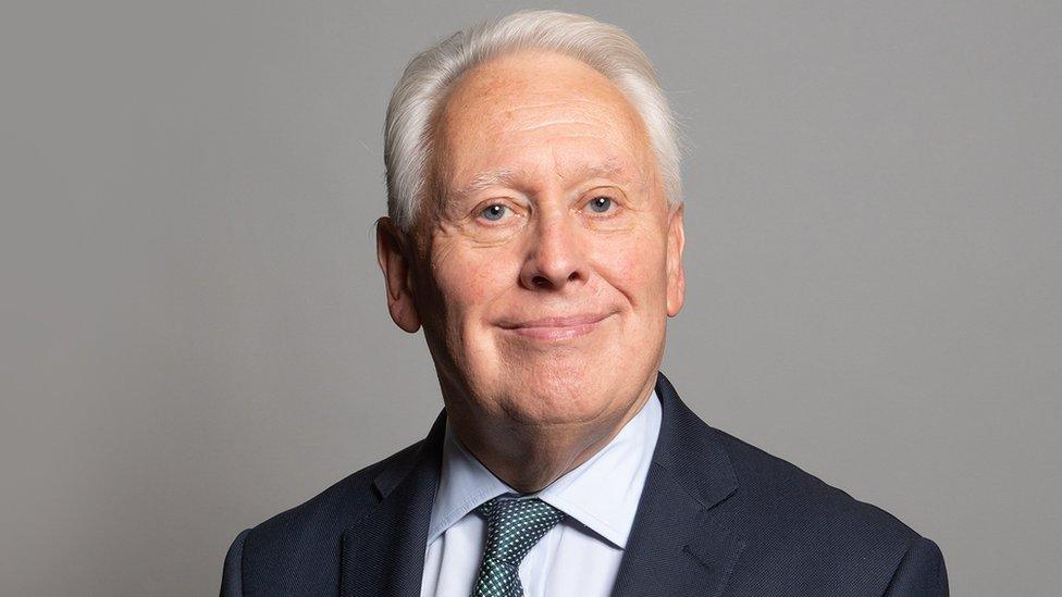 Sir Bob Neill smiling in official photo