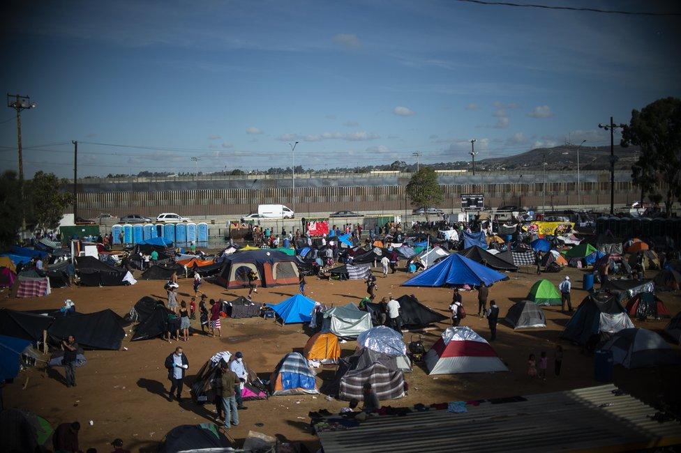 Central American migrants, mostly Hondurans, remain at a shelter near the US-Mexico border fence in Tijuana, 23 November