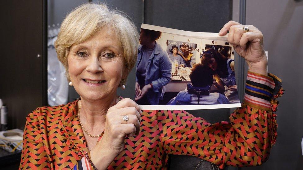 Debbie Rix pictured with a photograph of herself on the first day she presented BBC Breakfast