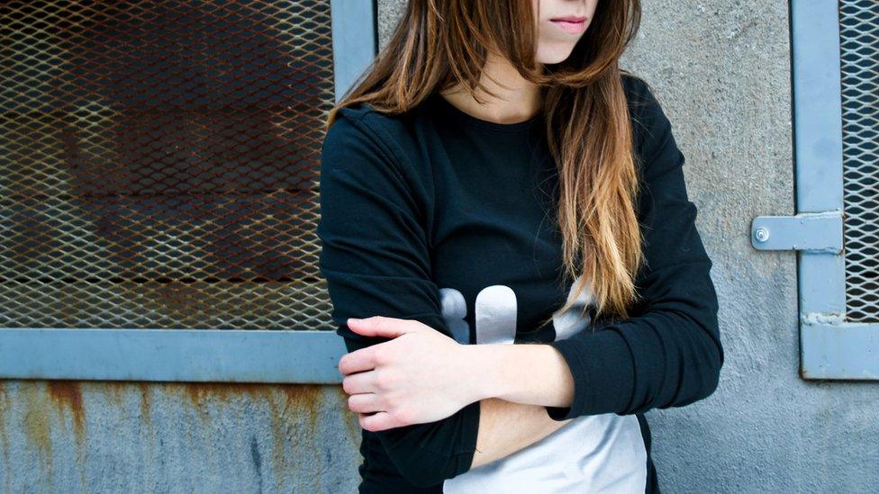 A stock image of a young girl with folded arms