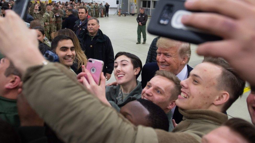 US President Donald Trump greets members of the US military during a stop at Ramstein Air Base in Germany, 27 December