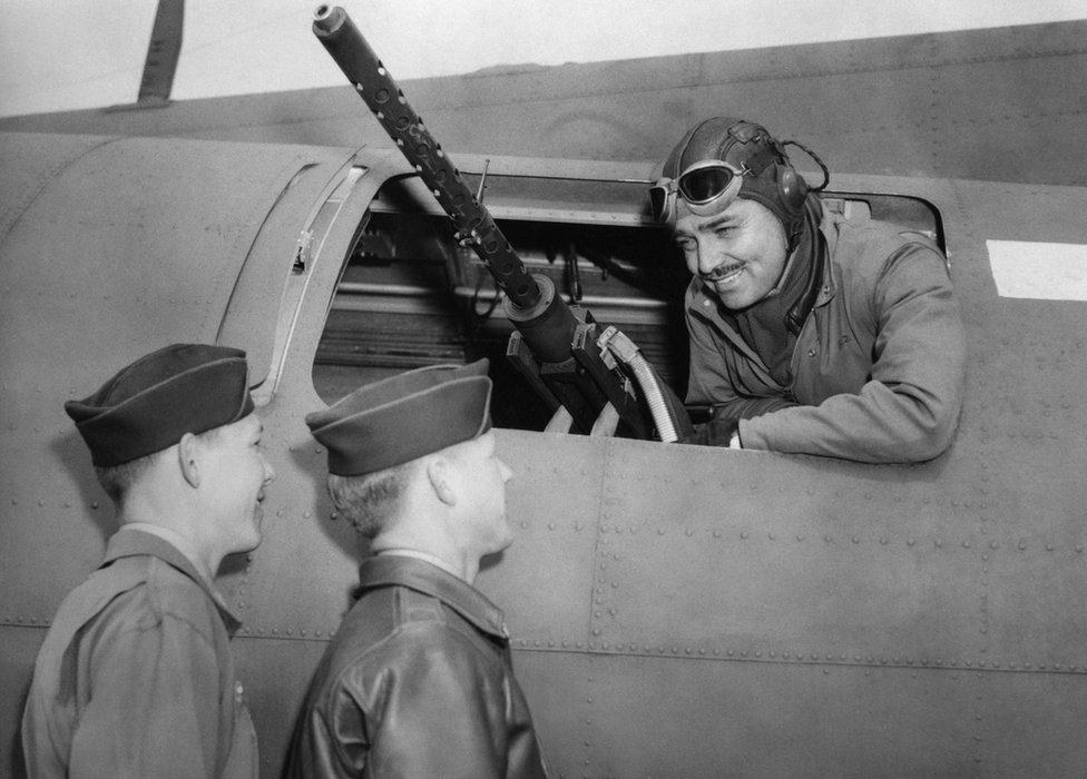 Captain Clark Gable talks to Sergeant Phil Hulse and Sergeant Kenneth Huls of the 351st Bomb Group