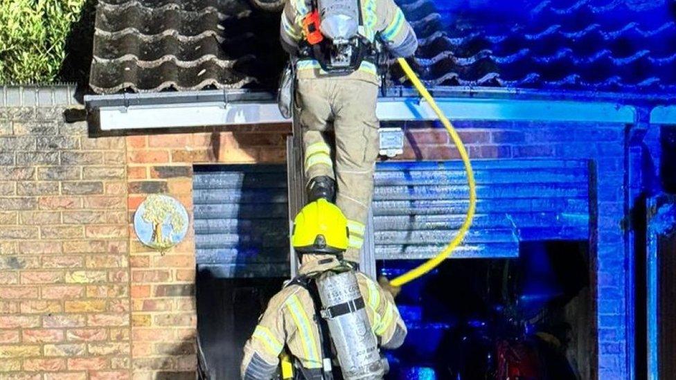 firefighters coming down a ladder