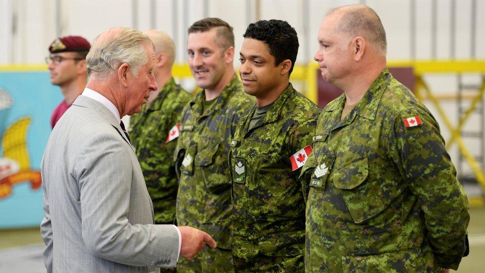 Charles speaks to people at the Trenton military base