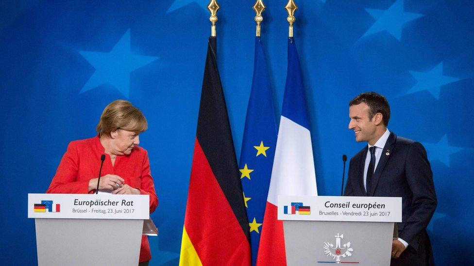 German Chancellor Angela Merkel (L) and French President Emmanuel Macron (R) give a joint press conference