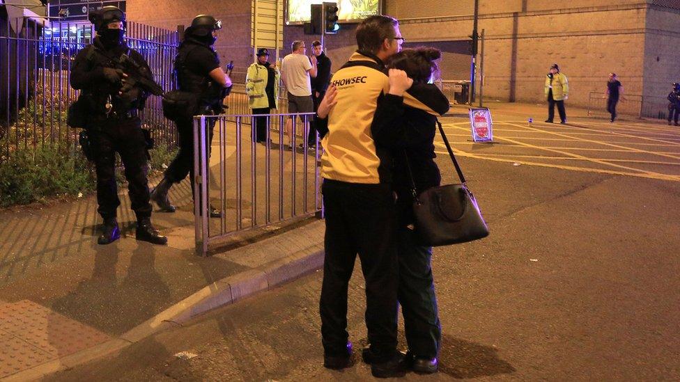 Armed police arrive as arena staff hug