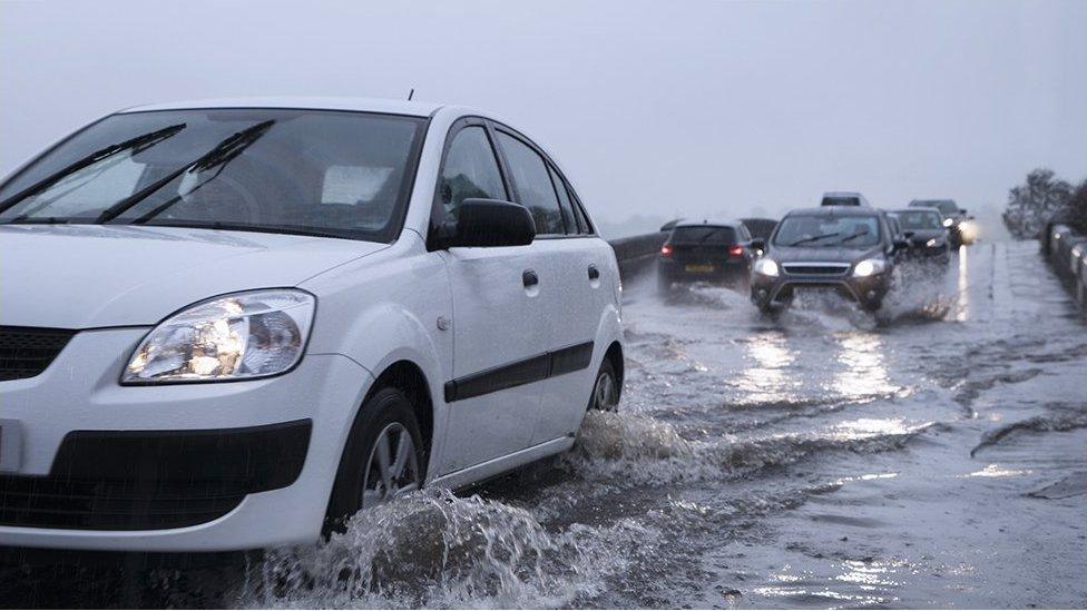 Cars on flooded Leeds road