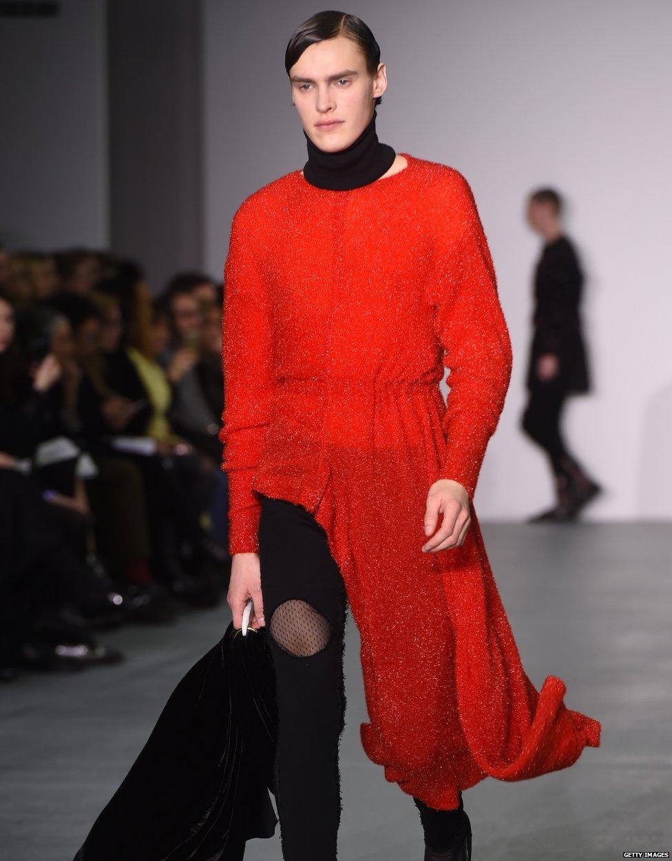 A male model wearing half dress half trousers at London Fashion Week