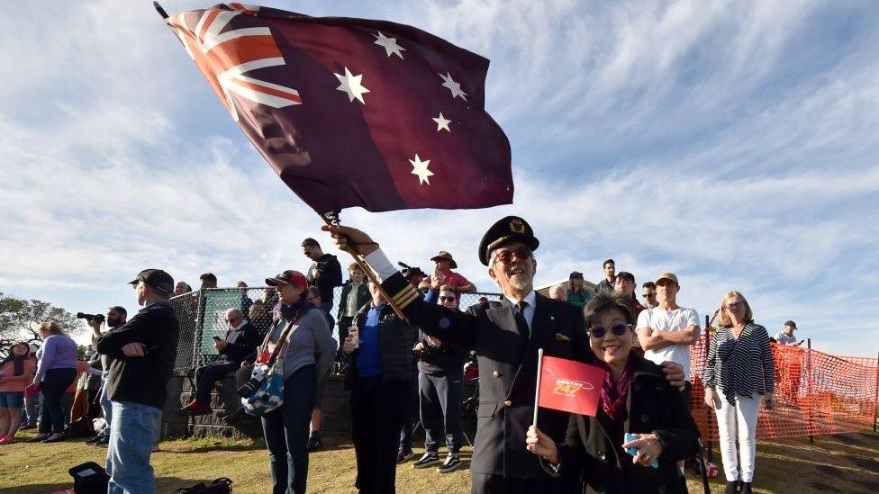 People watch as the last Qantas Boeing 747 airliner departs from Sydney airport to the US on July 22, 2020