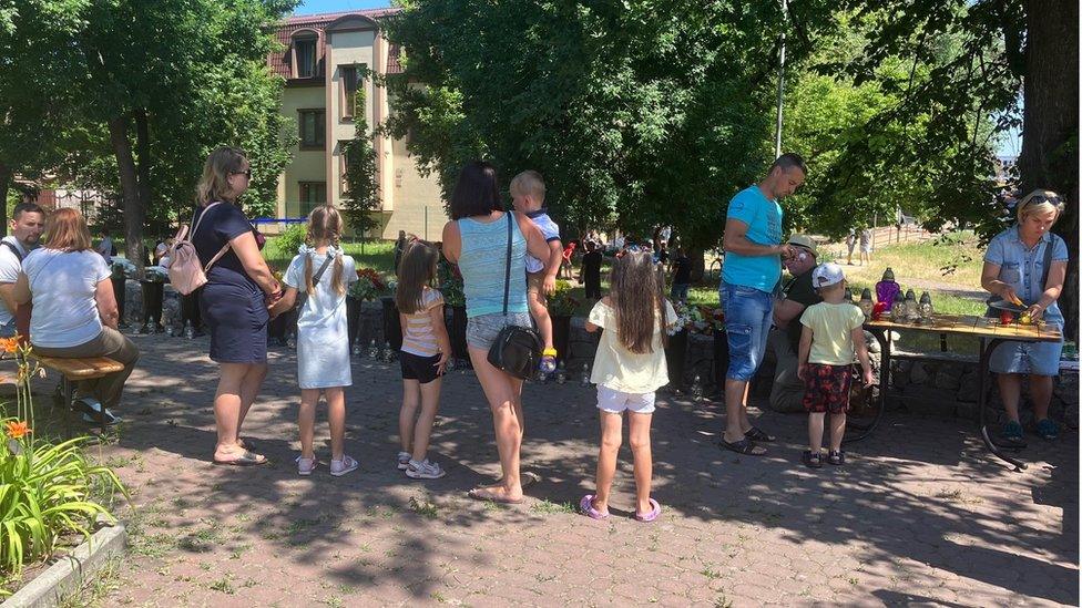 A small crowd gathers outside the mall