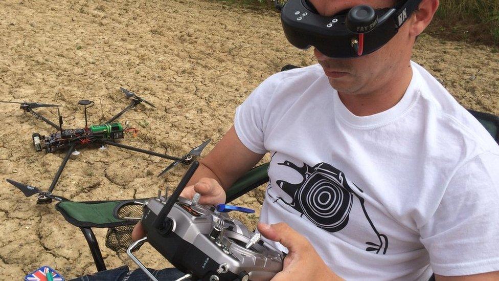 Lee controlling a drone and viewing the video images it sends on his goggles through the device's 'eyes', its cameras