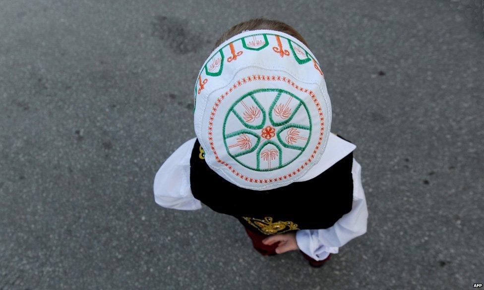 A child stands in a mosque following Eid al-Fitr ceremony in Pristina