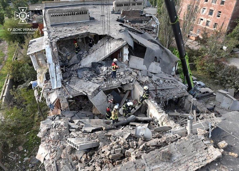 Rescuers comb through the rubble after a residential building was destroyed in a Russian missile attack in Mykolaiv, southern Ukraine. Photo: 13 October 2022