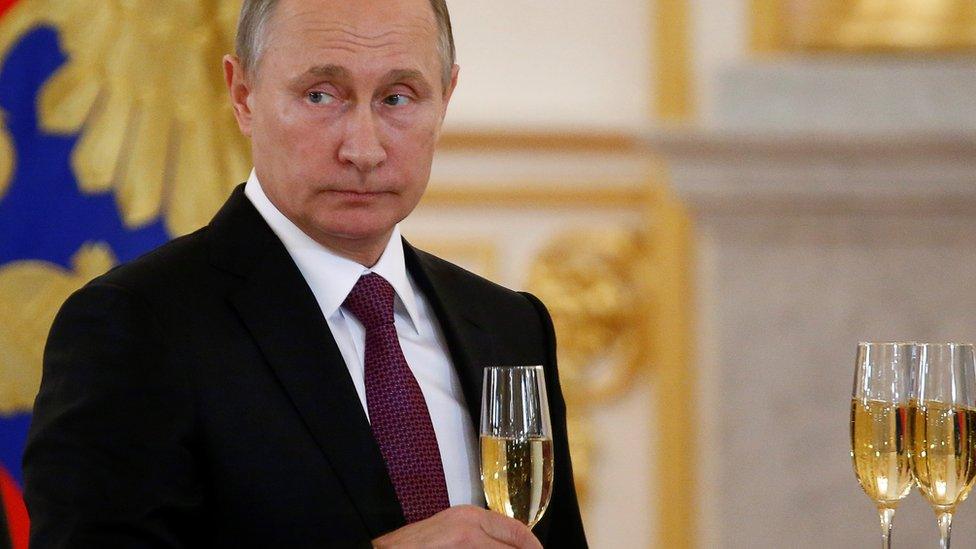 Vladimir Putin makes a toast during a ceremony in Russia