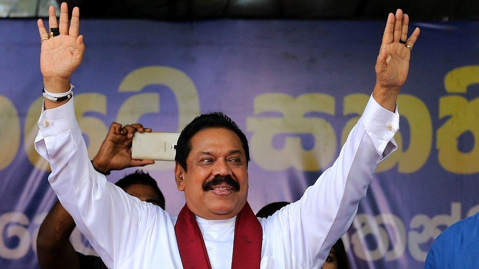 Mahinda Rajapaksa waves to supporters during his partys final day of election campaign rally