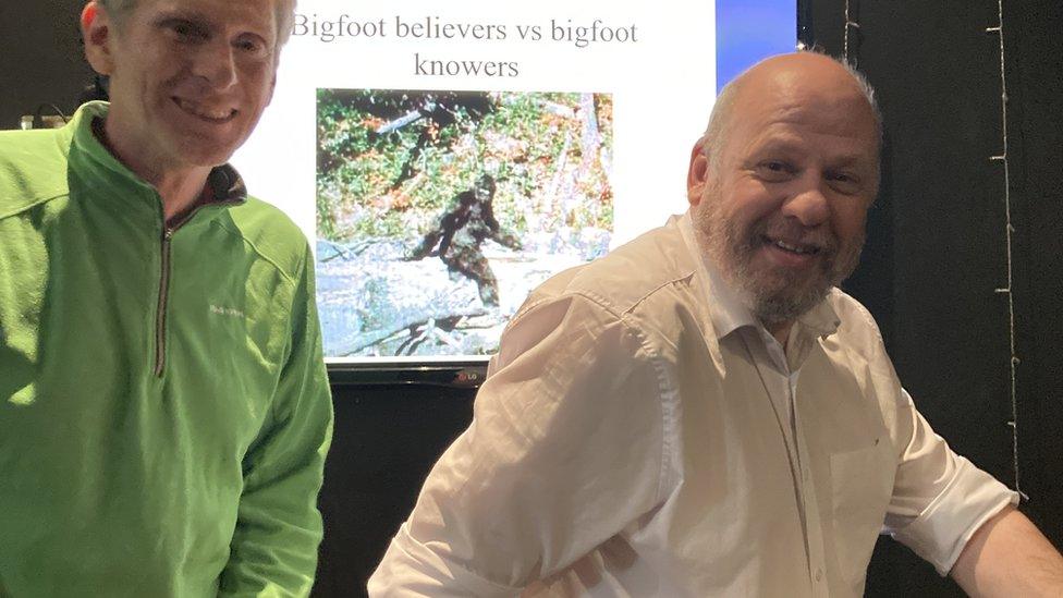 Eddy Cory a Fortean society member and Gordon Rutter posing in front of Bigfoot slide