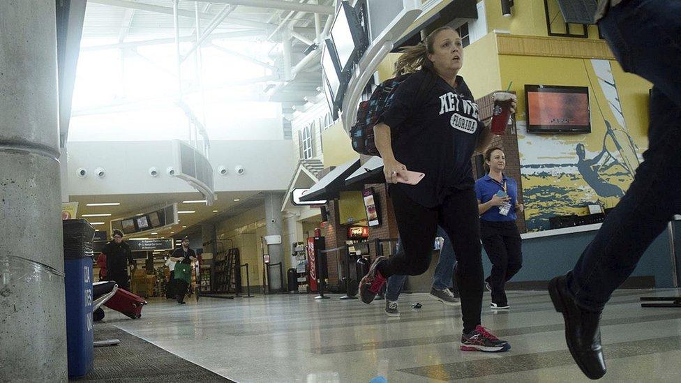 Passengers run for cover in Terminal 1 at Fort Lauderdale's "Hollywood International Airport, Friday, Jan. 6, 2017, in Fort Lauderdale, Fla