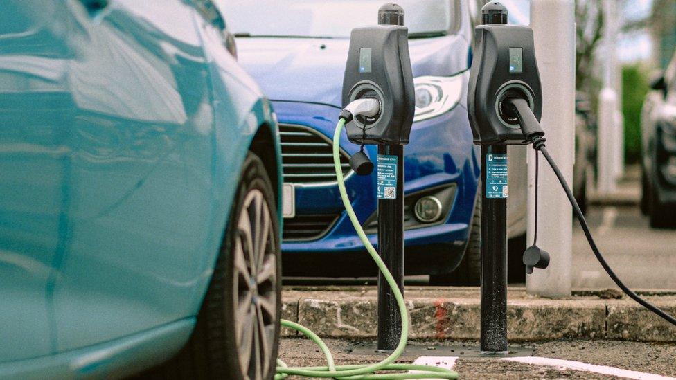 A car plugged into an EV charger