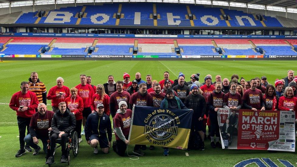 Participants pose for group shot at Bolton