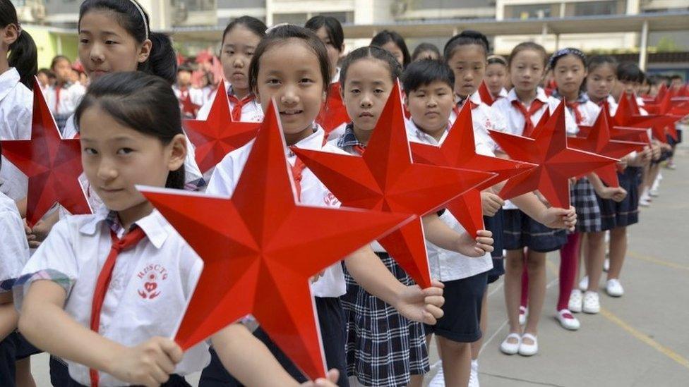 Students pose with red stars during an event to mark the 70th anniversary of the Victory of Chinese People"s War of Resistance Against Japanese Aggression and the World Anti-Fascist War, at a primary school in Handan, Hebei province, China, August 31, 2015.