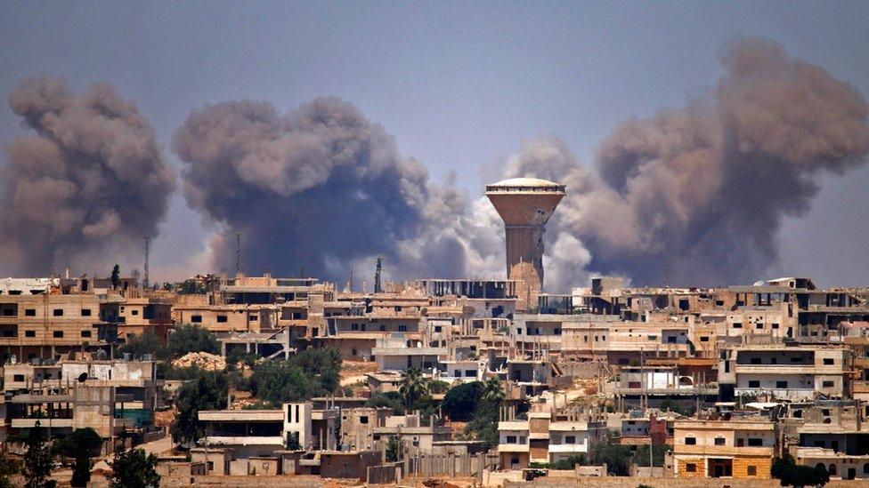 Smoke rises from a rebel-held area in the Syrian city of Deraa after a reported government air strike on 5 July 2018