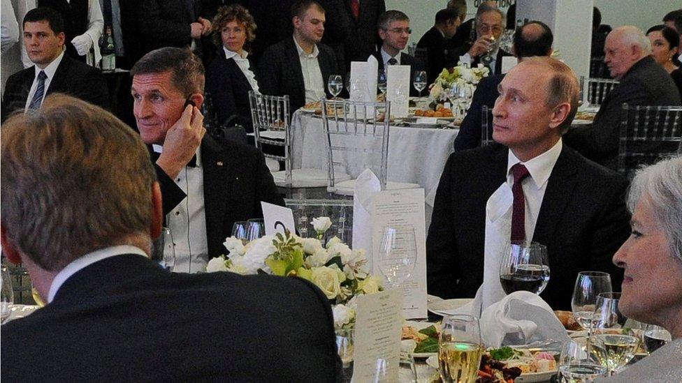 In this file photo taken on 10 December 2015, Russian President Vladimir Putin is seen centre right with retired US Lt Gen Michael Flynn, center left