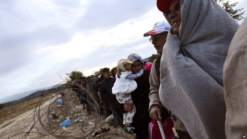 Refugees and migrants wait to pass the borders from the northern Greek village of Idomeni to southern Macedonia