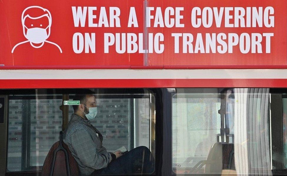 Person wearing mask on bus