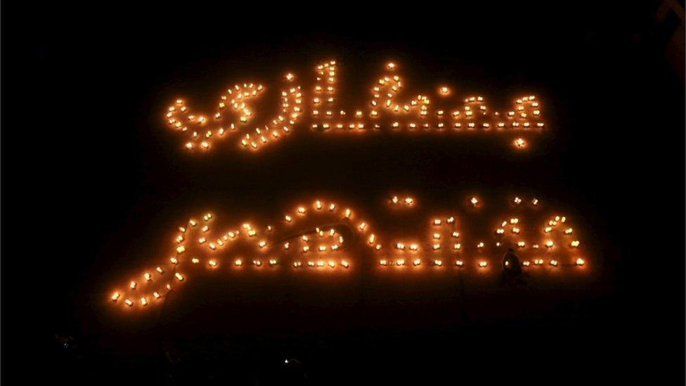 Lighted candles form the words "Benghazi win" during a show of support for the Libyan army in the ongoing conflict, in Benghazi, Libya February 26, 2016