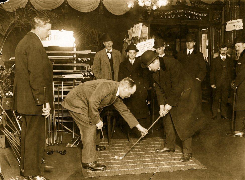 Golf champion John Henry Taylor instructing customers at Harrods in 1914