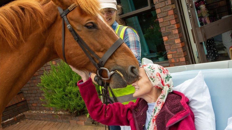 Hayley Golding with a horse outside a hospice in Aylesbury