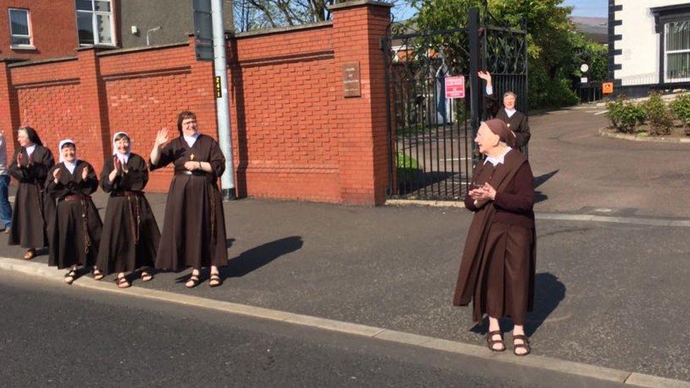 Martina Purdy and other nuns from the Sisters of Adoration cheer on competitors on the Falls Road, Belfast Coty Marathon, 1st May 2017