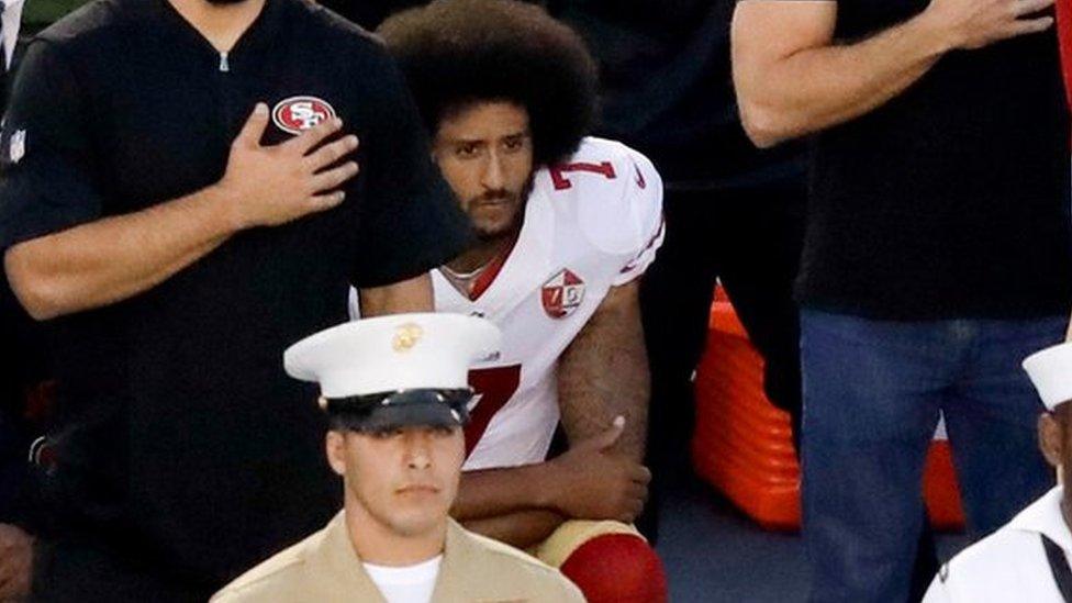 San Francisco 49ers quarterback Colin Kaepernick, middle, kneels during the national anthem before the team"s NFL preseason football game against the San Diego Chargers, Thursday, Sept. 1, 2016, in San Diego