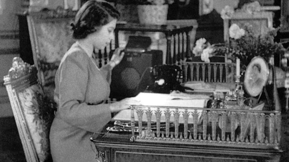 A picture of the Queen, whilst still a princess, switching on a Roberts radio in 1944