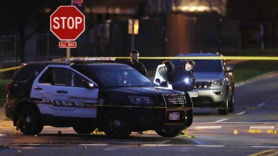 Police officers gather evidence at the scene of a shooting, Wednesday, Nov. 2, 2016, in Urbandale, Iowa