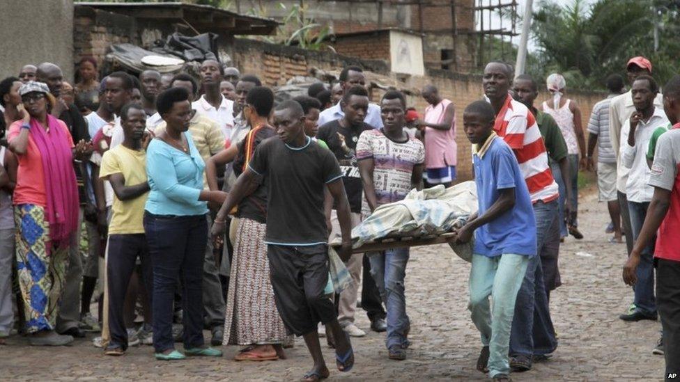 Men carry away a dead body in the Nyakabiga neighbourhood of Bujumbura