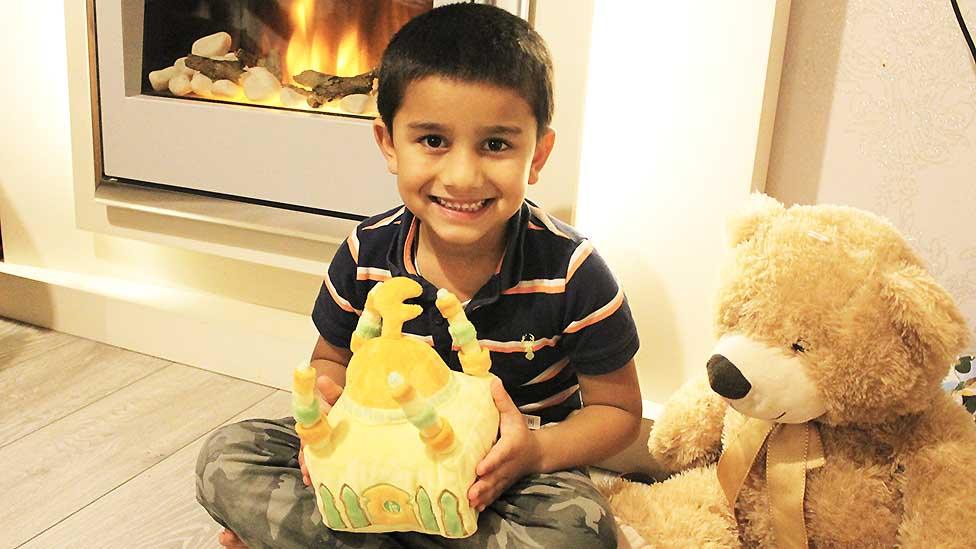 Boy with soft toy mosque