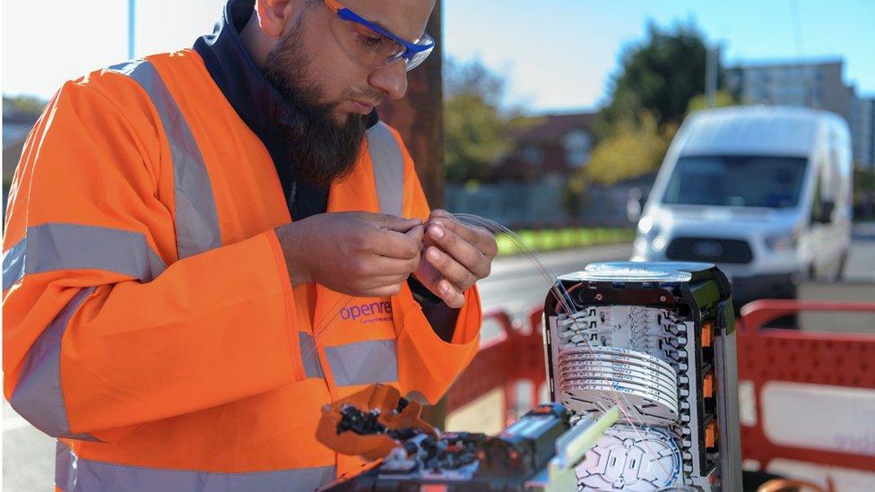 BT engineer handling fibre cables