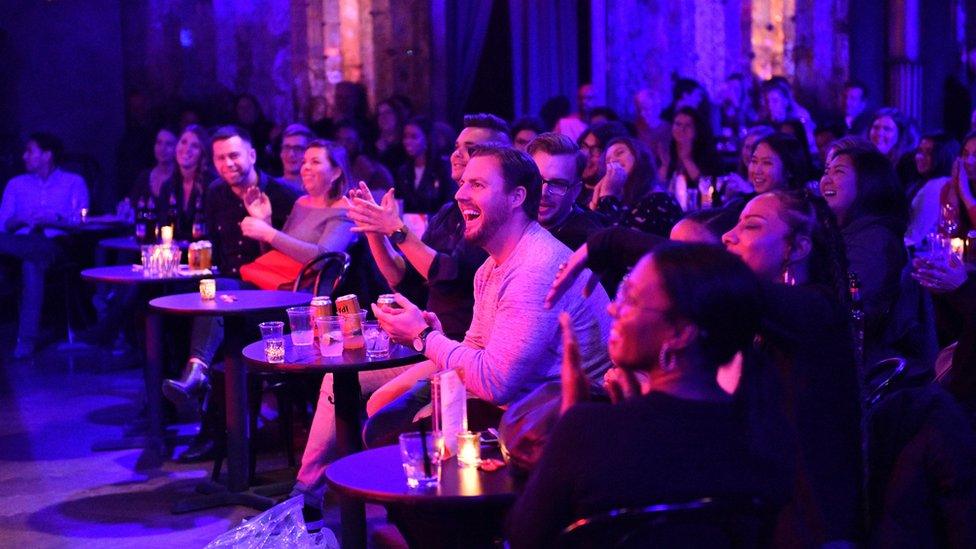 Audience members at a comedy show